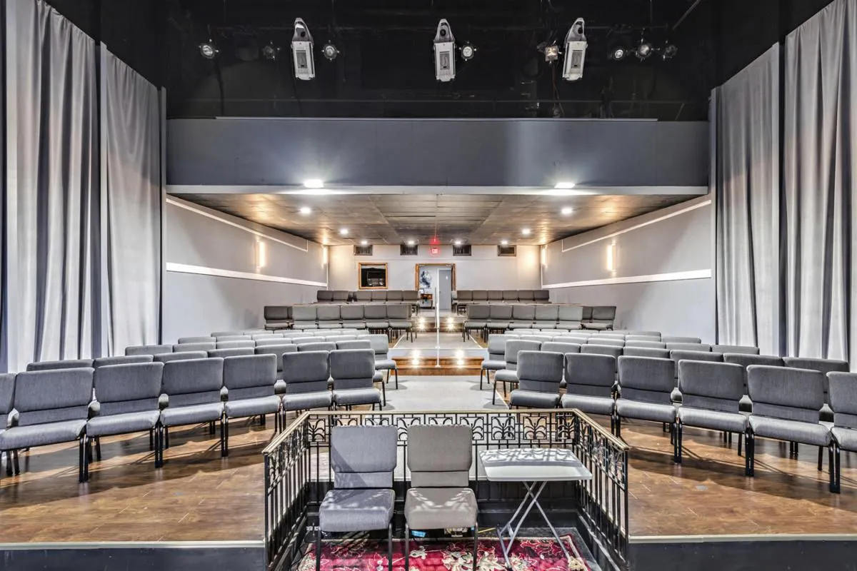 Auditorium seating facing the stage at the Blue Bird Theatre